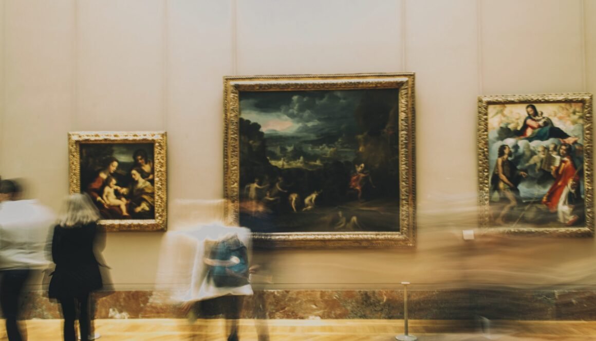 woman in white dress standing near painting