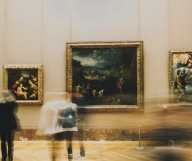 woman in white dress standing near painting